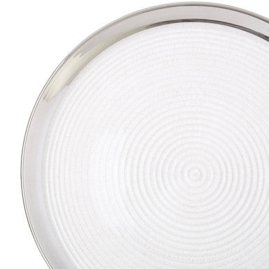 Close-up detail of the silver rim and embossed texture on the coupe charger plate