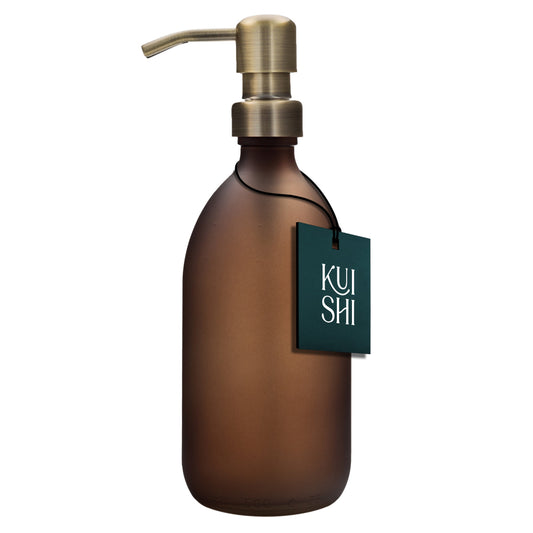 Brown soap dispenser with gold pump and 'Kuishi' tag on a white background