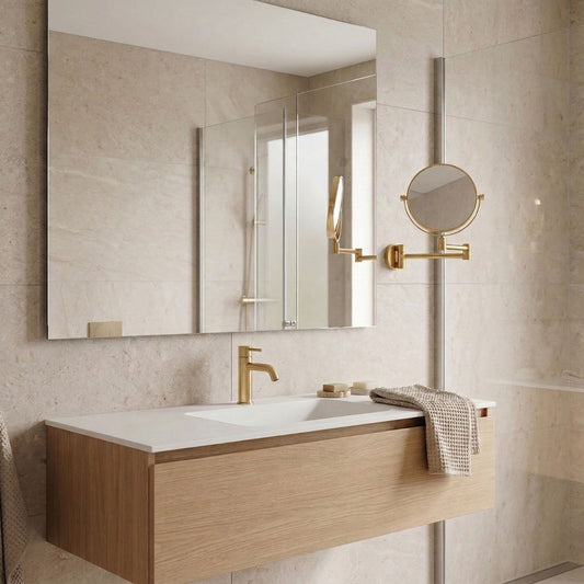 Modern bathroom with brass fittings, including wall-mounted shaving mirror.