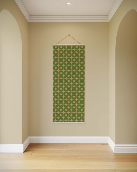 Green patterned wall hanging on a beige wall with wooden floor