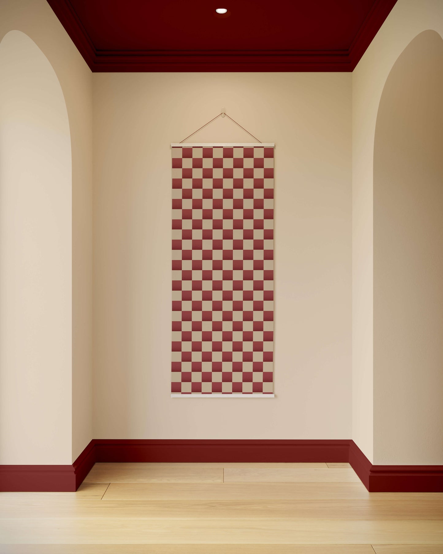 Checkered tapestry hanging on a wall with arched doorways and a red ceiling.
