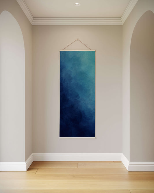 Blue abstract painting hanging on a wall in a room with wooden flooring.