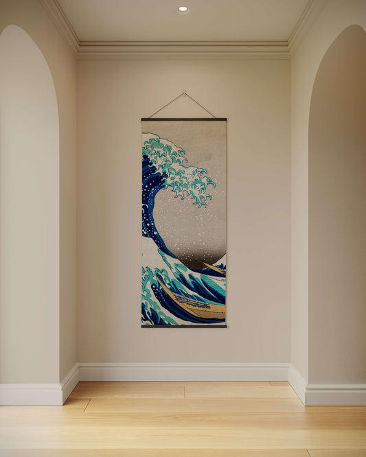 Decorative tapestry of a wave hanging on a wall in a room with wooden flooring.