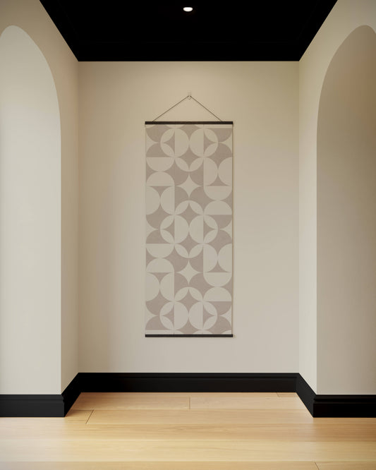 Decorative wall hanging with geometric pattern in a minimalistic room.