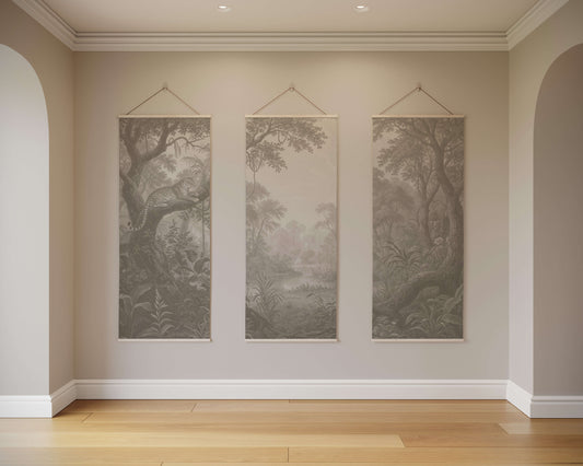 Three landscape paintings hanging on a wall in a room with wooden flooring.