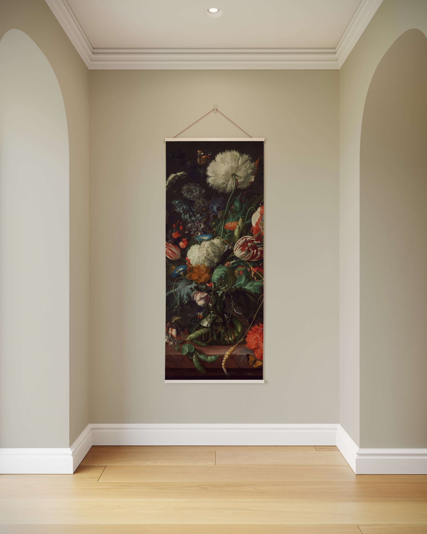 Floral still life painting hanging on a wall in a room with light-colored walls and wooden floor.