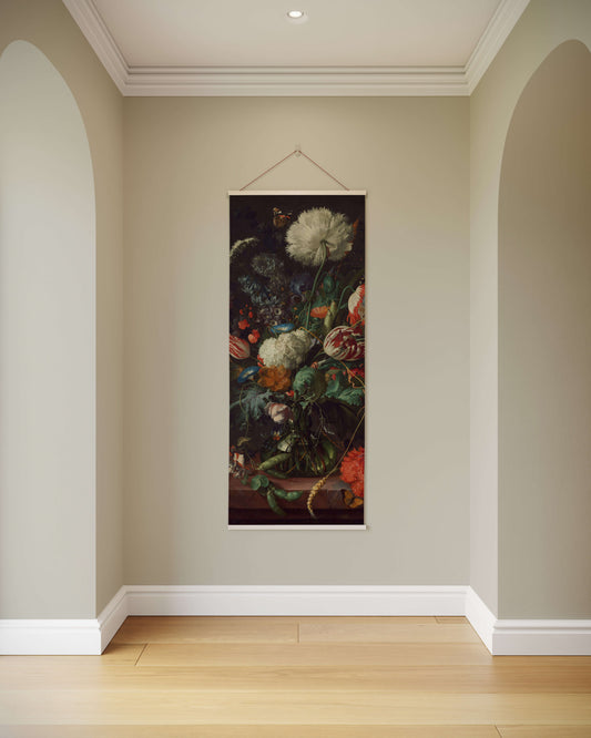 Floral still life painting hanging on a wall in a room with light-colored walls and wooden floor.