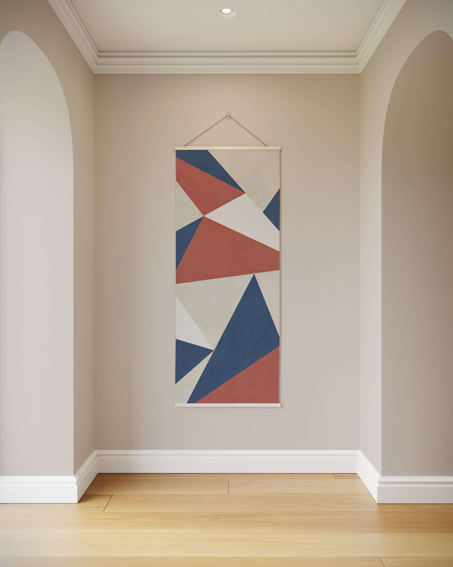 Geometric abstract art hanging on a wall in a room with wooden flooring.