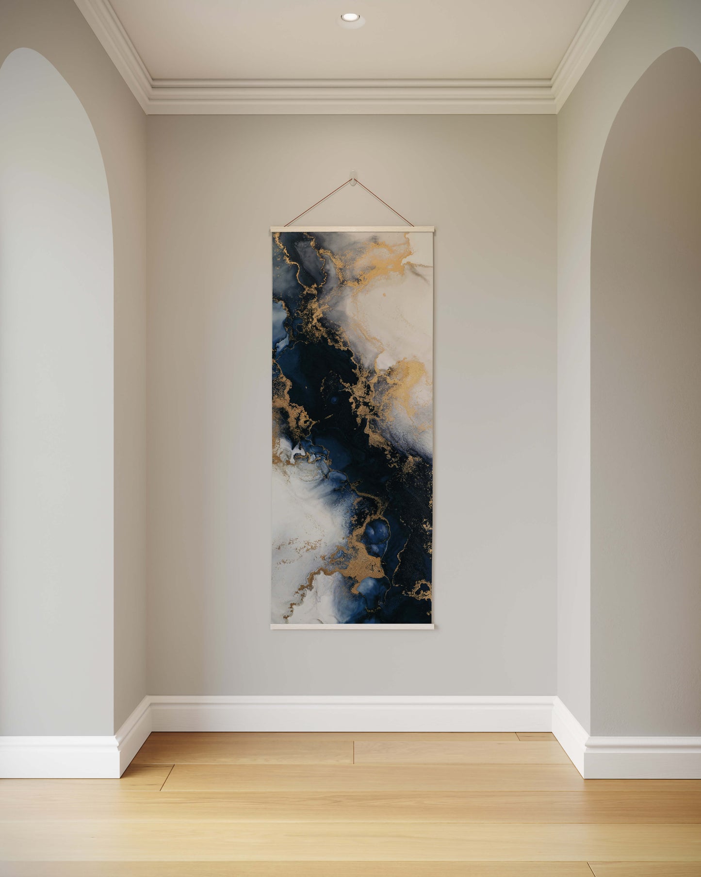 Abstract art piece hanging on a wall in a room with light-coloured walls and a wooden floor.