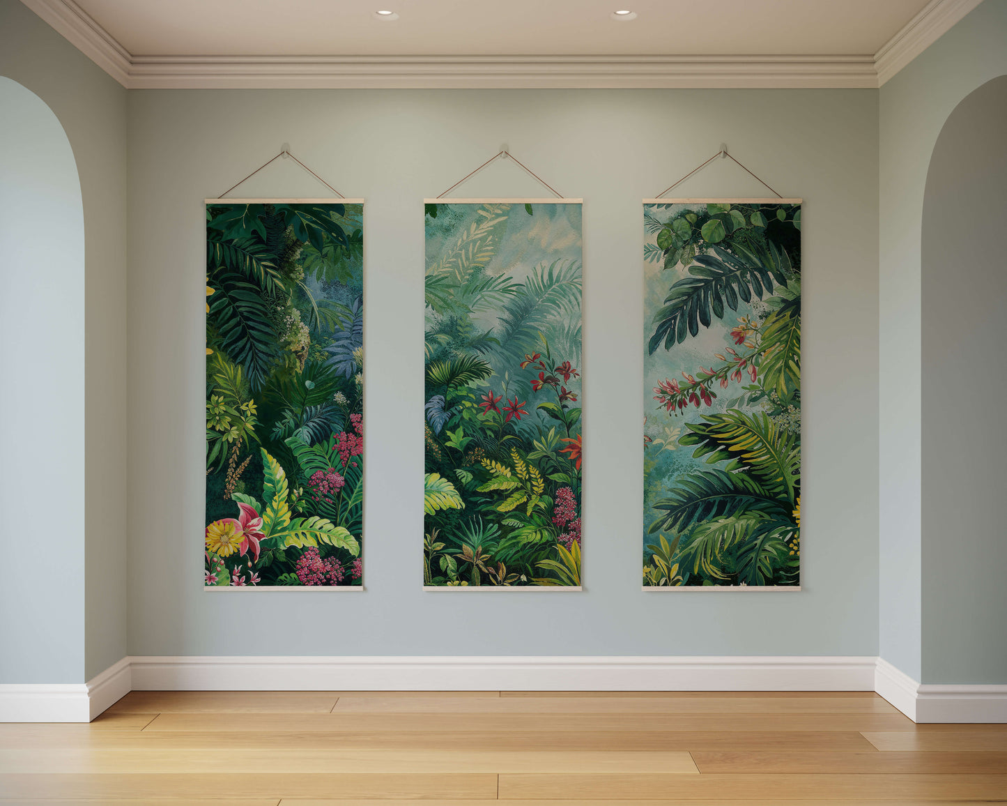 Three vertical tropical leaf artworks hanging on a light gray wall.