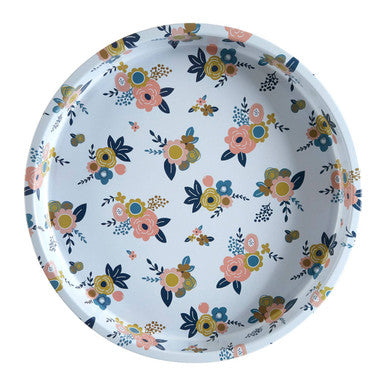 Round metal serving tray with yellow floral motif on white base