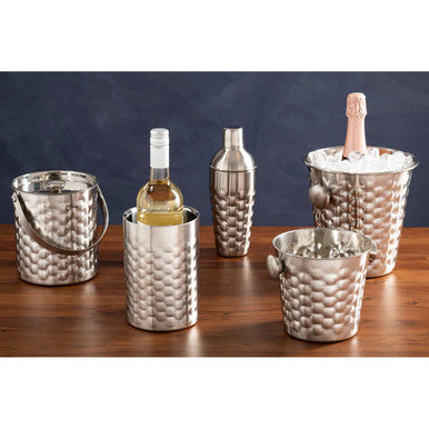 Set of silver wine coolers with bottles on a wooden surface