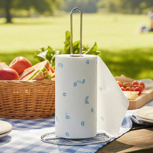 Helix Chrome Kitchen Roll Holder on a picnic table outside in a park setting