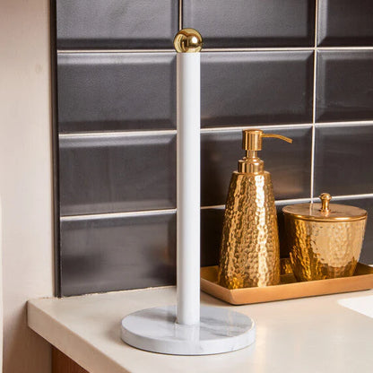 Easton White Marble Effect & Gold Kitchen Roll Holder on a marble stand against a tiled wall.