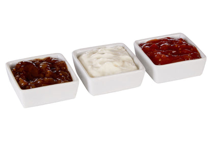 Three white serving dishes styled with antipasti