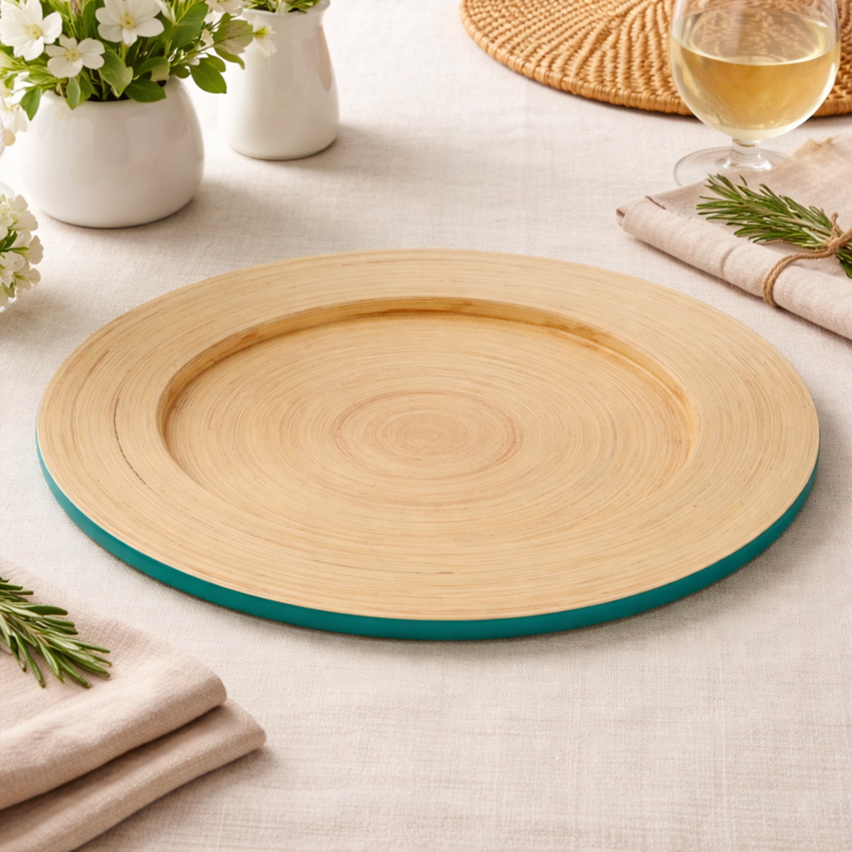 Turquoise bamboo charger plate laid beneath a dinner plate