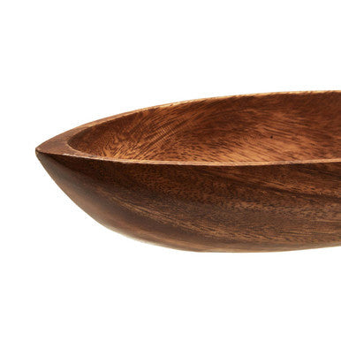 Boat shaped serving dish on a dining table