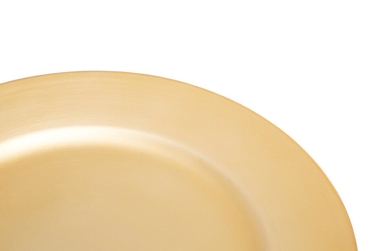 Gold charger plate laid beneath a dinner plate in a table setting