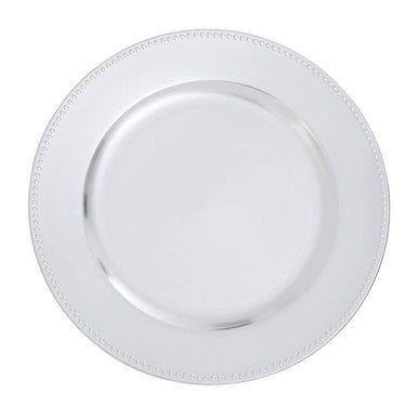 Close-up detail of the dotted rim on the silver charger plate
