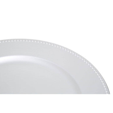 Silver charger plate styled with tableware for a formal dinner setting