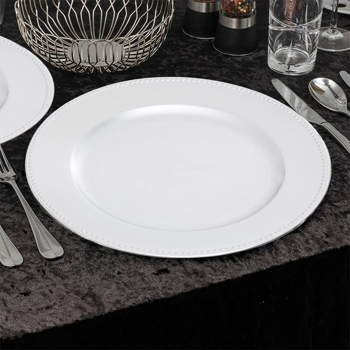 Side view of the silver charger plate showing the dotted rim