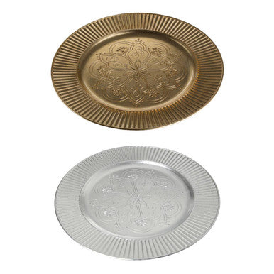 Close-up detail of the embossed redbud floral pattern on the silver charger plate