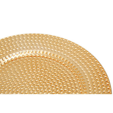 Close-up detail of the hammered texture on the gold charger plate