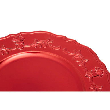 Red baroque charger plate styled with tableware for a festive dinner