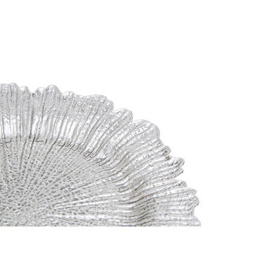 Silver reef charger plate styled with tableware for a formal dinner