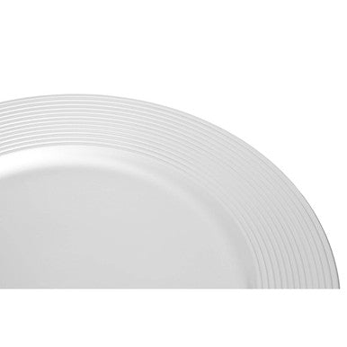 Silver charger plate laid beneath a dinner plate in a table setting