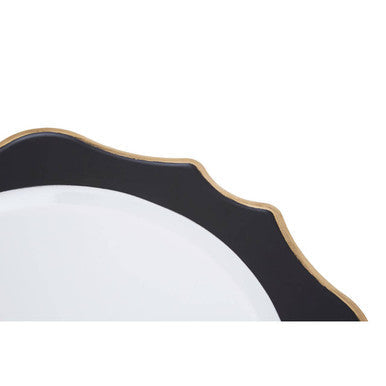 Close-up detail of the black and white charger plate's scalloped edge