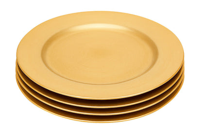 Gold charger plate styled on a dining table as part of a place setting