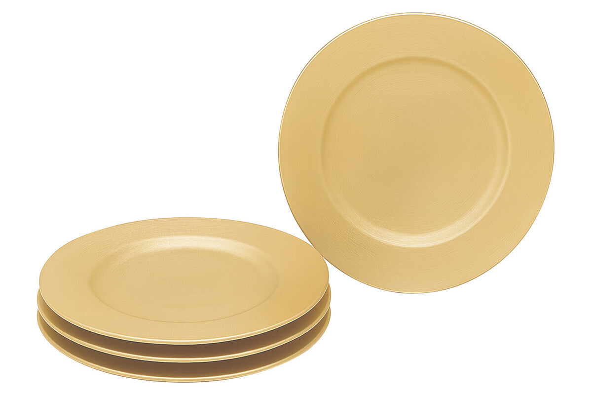 Gold charger plate laid beneath a dinner plate in a table setting