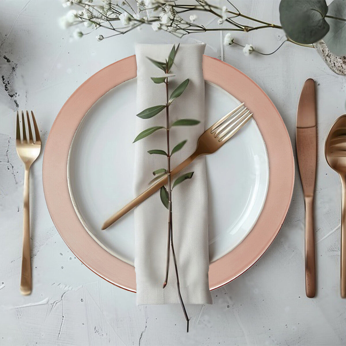 Rose gold charger plate styled on a dining table as part of a place setting