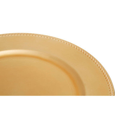 Close-up detail of the dotted rim pattern on the gold charger plate