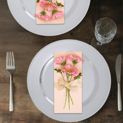 Silver charger plate styled with tableware for a formal dinner