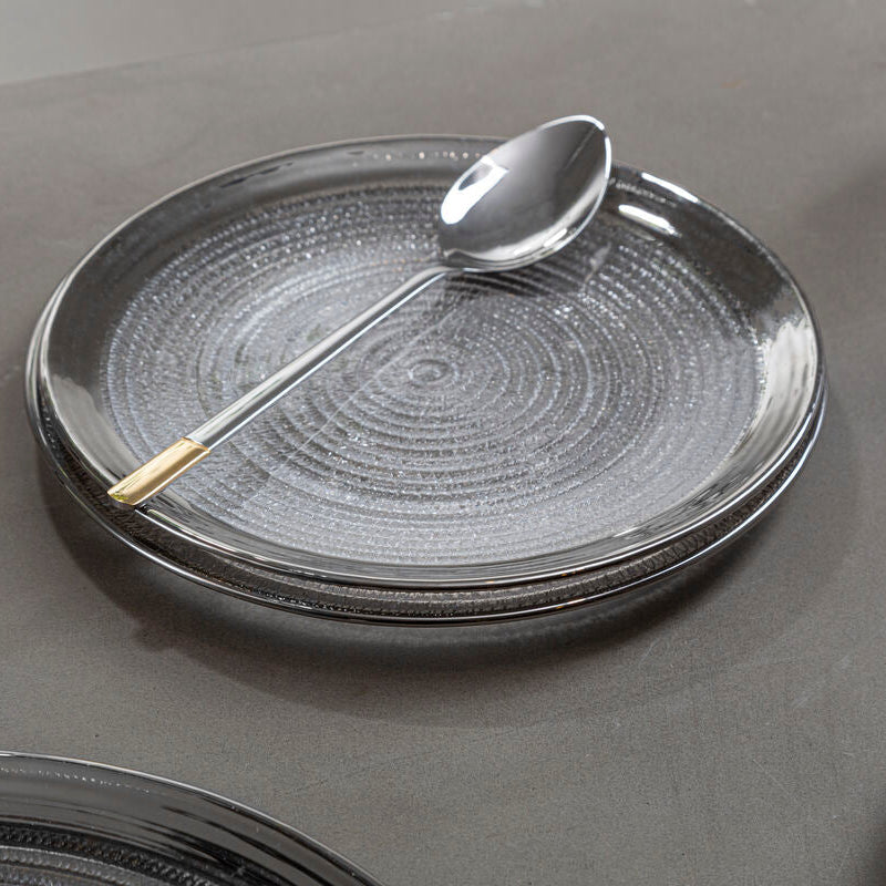 Clear embossed glass charger plate with a silver rim, 33cm diameter