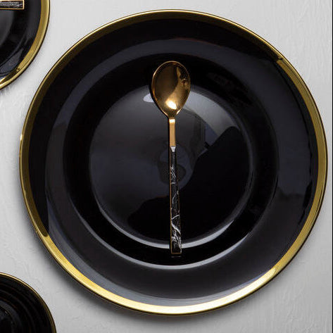 Black glass charger plate with a gold rim, 33cm diameter