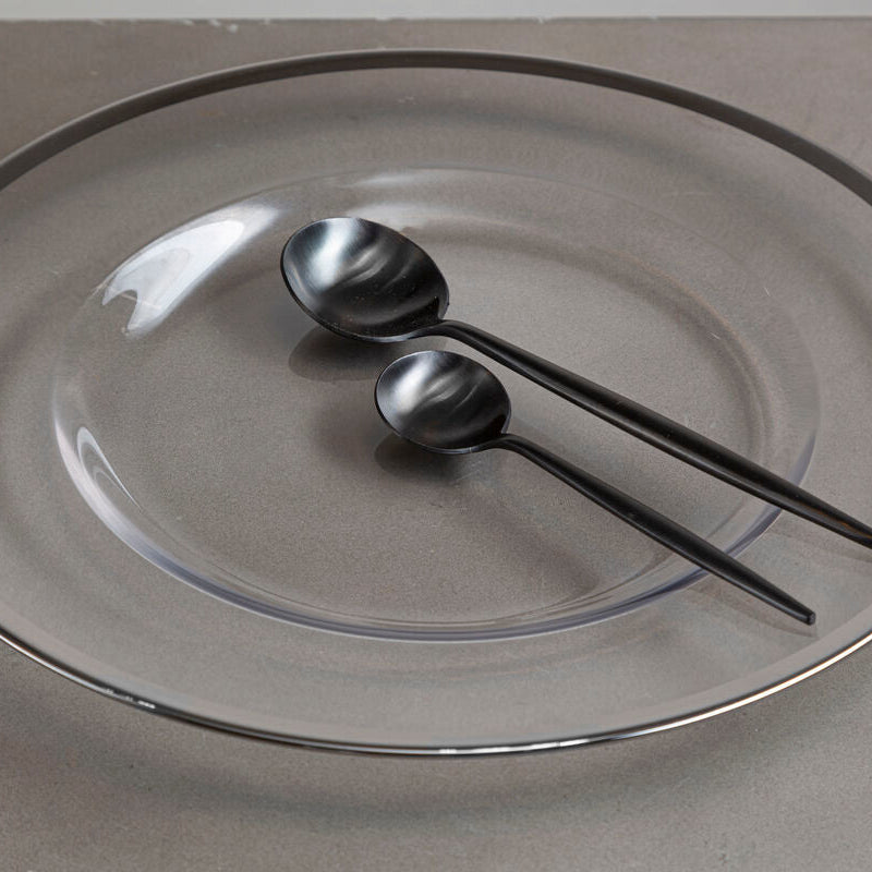 Glass charger plate with silver rim shown from above