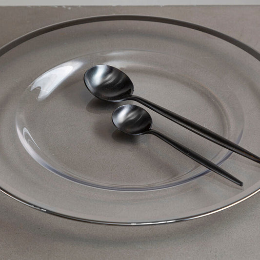 Glass charger plate with silver rim shown from above