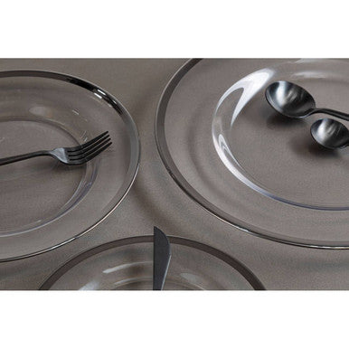 Glass charger plate styled with tableware for a formal dinner setting