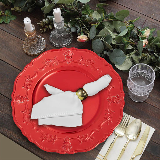 Red baroque charger plates stacked showing the scrollwork detail