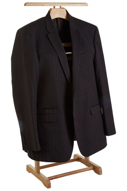 A black pinstripe suit jacket displayed on a wooden hanger and stand against a plain white background.