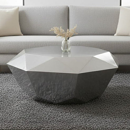 Geometric coffee table in a living room setting with a vase on top