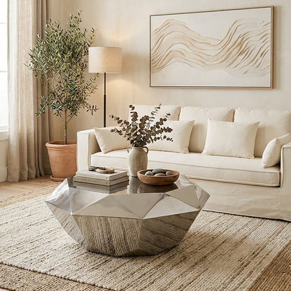 Modern living room with a beige sofa, geometric coffee table, and abstract wall art.
