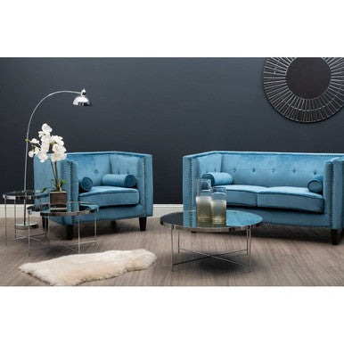 Blue sofa set with a coffee table and decorative items in a modern living room.