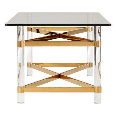 Glass table with gold and clear acrylic legs on a white background