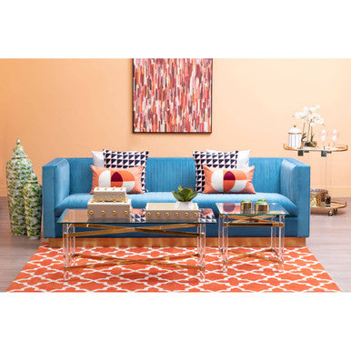 Blue sofa with colorful cushions in a living room setting.