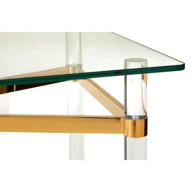 Glass table with gold and clear acrylic legs on a white background