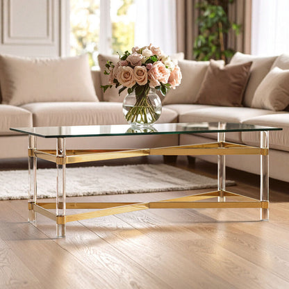 Glass coffee table with gold base in a living room setting